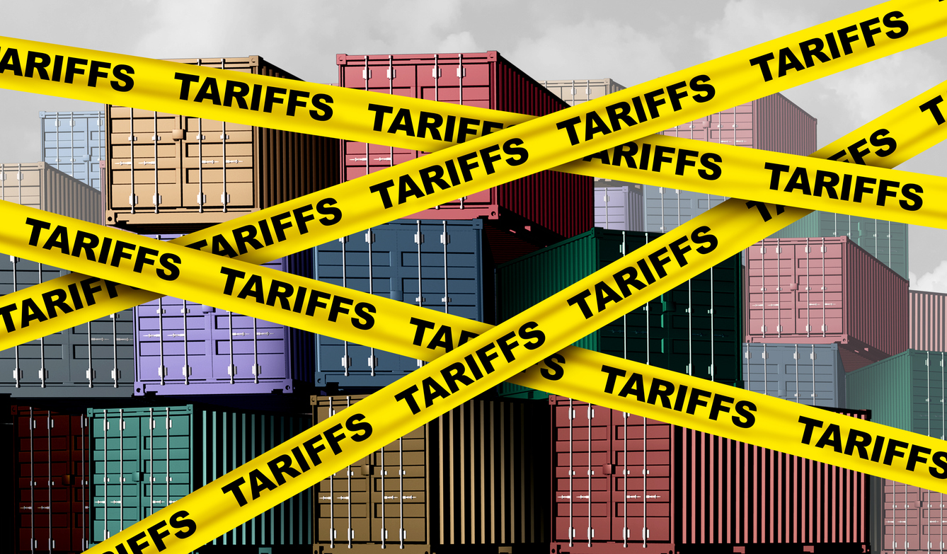 Caution tape with the word "TARIFF" printed across, covering shipping containers