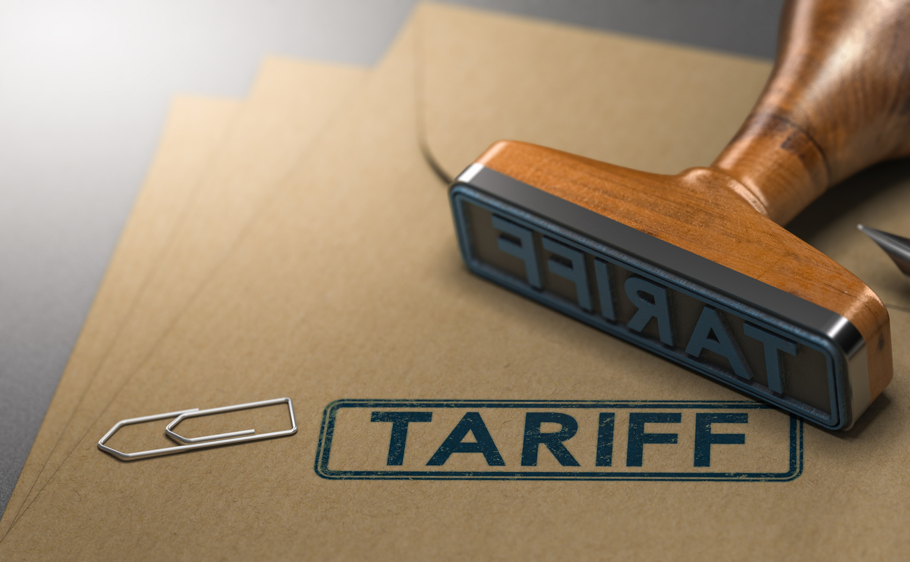 3D illustration of a rubber stamp with the word tariff stamped on paper background. Concept of taxes or duties on imported goods.