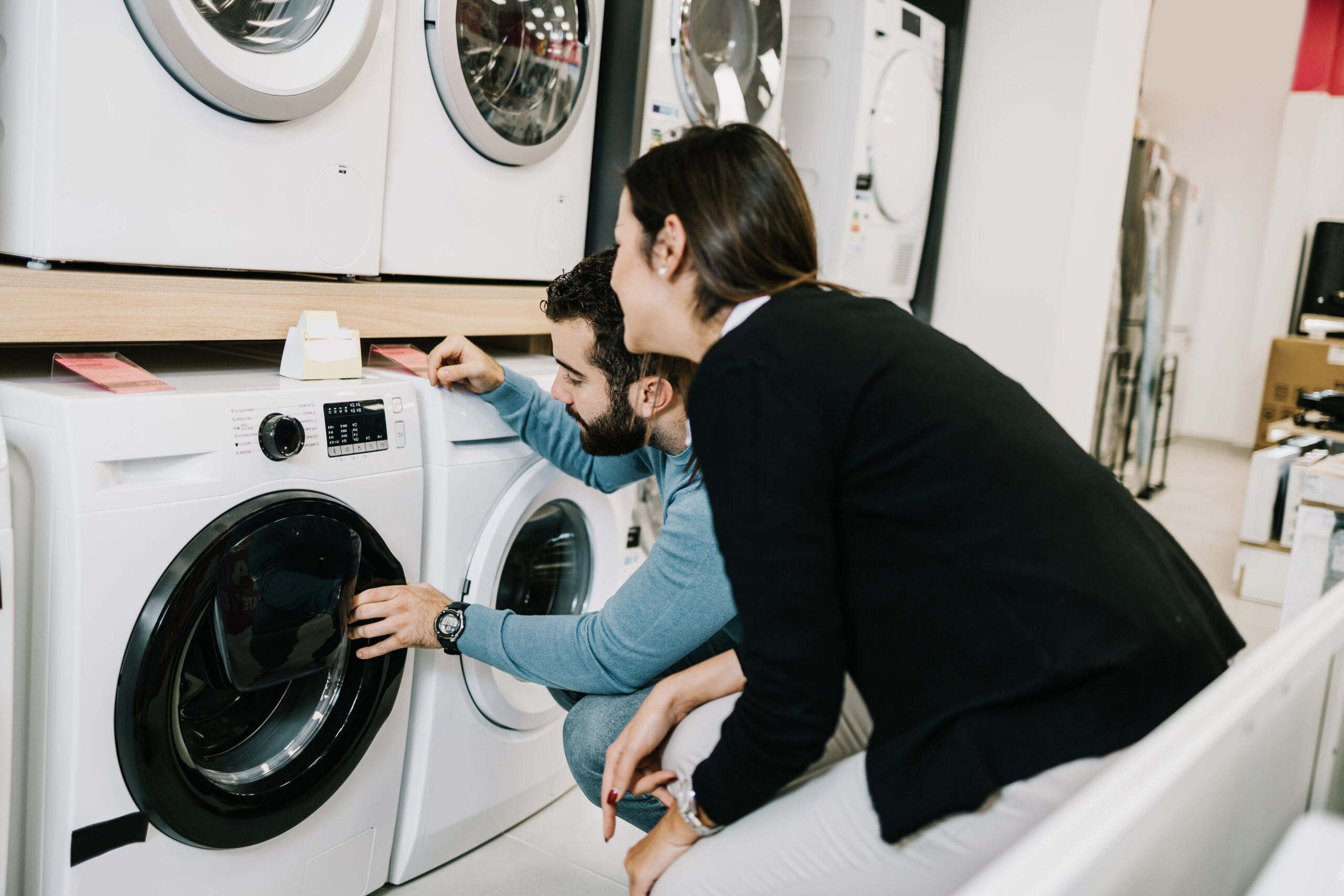 Man and woman shopping for a washing machine